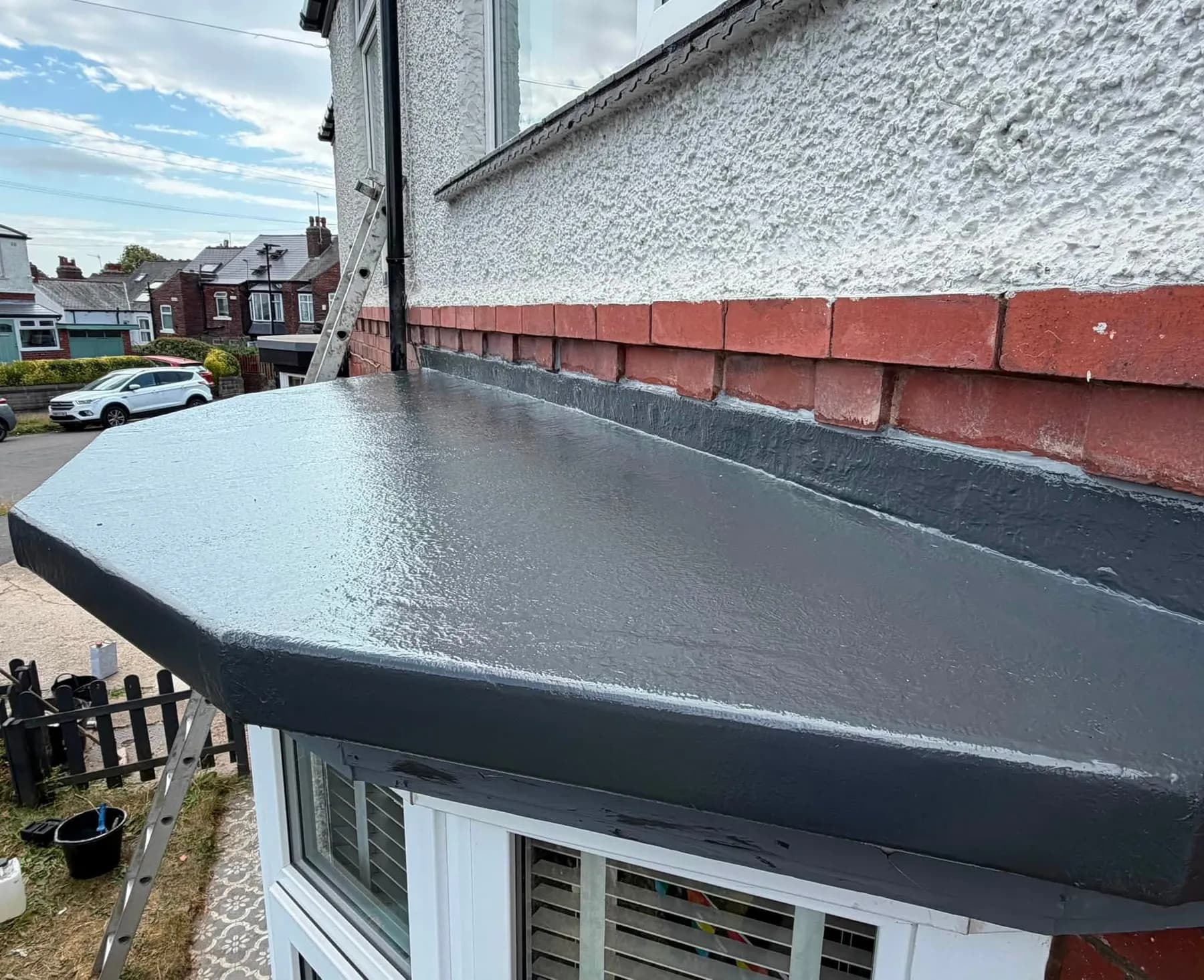 A finished black GRP roof on a bay window