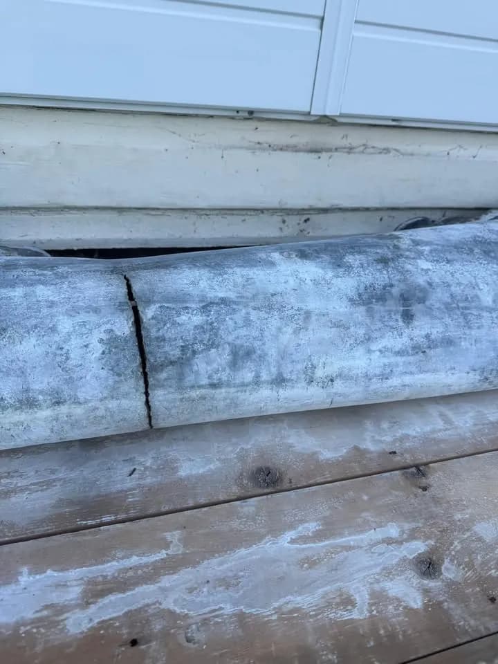 A crack through the old lead roll on the bay roof