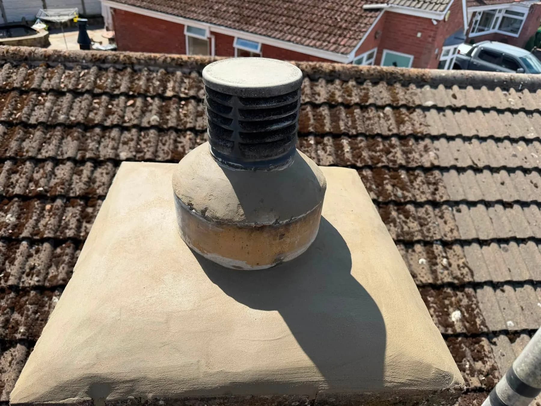 A chimney pot re-bedded in smooth new flaunching