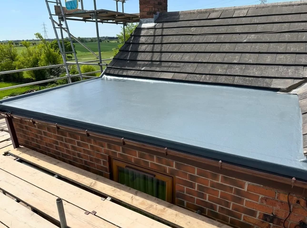 The finished grey GRP flat roof, below the tiled roof