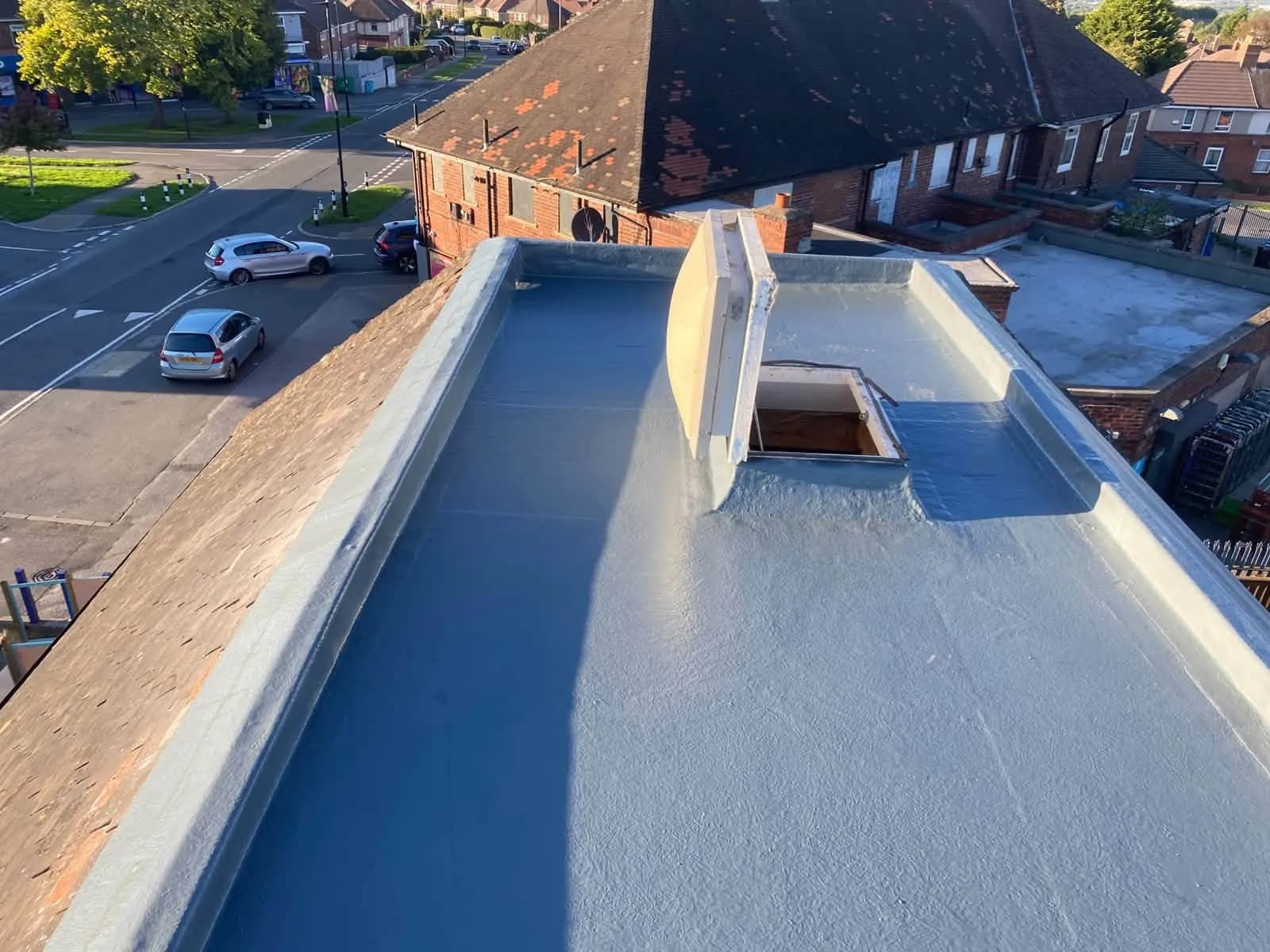The finished grey GRP roof with new edge trims