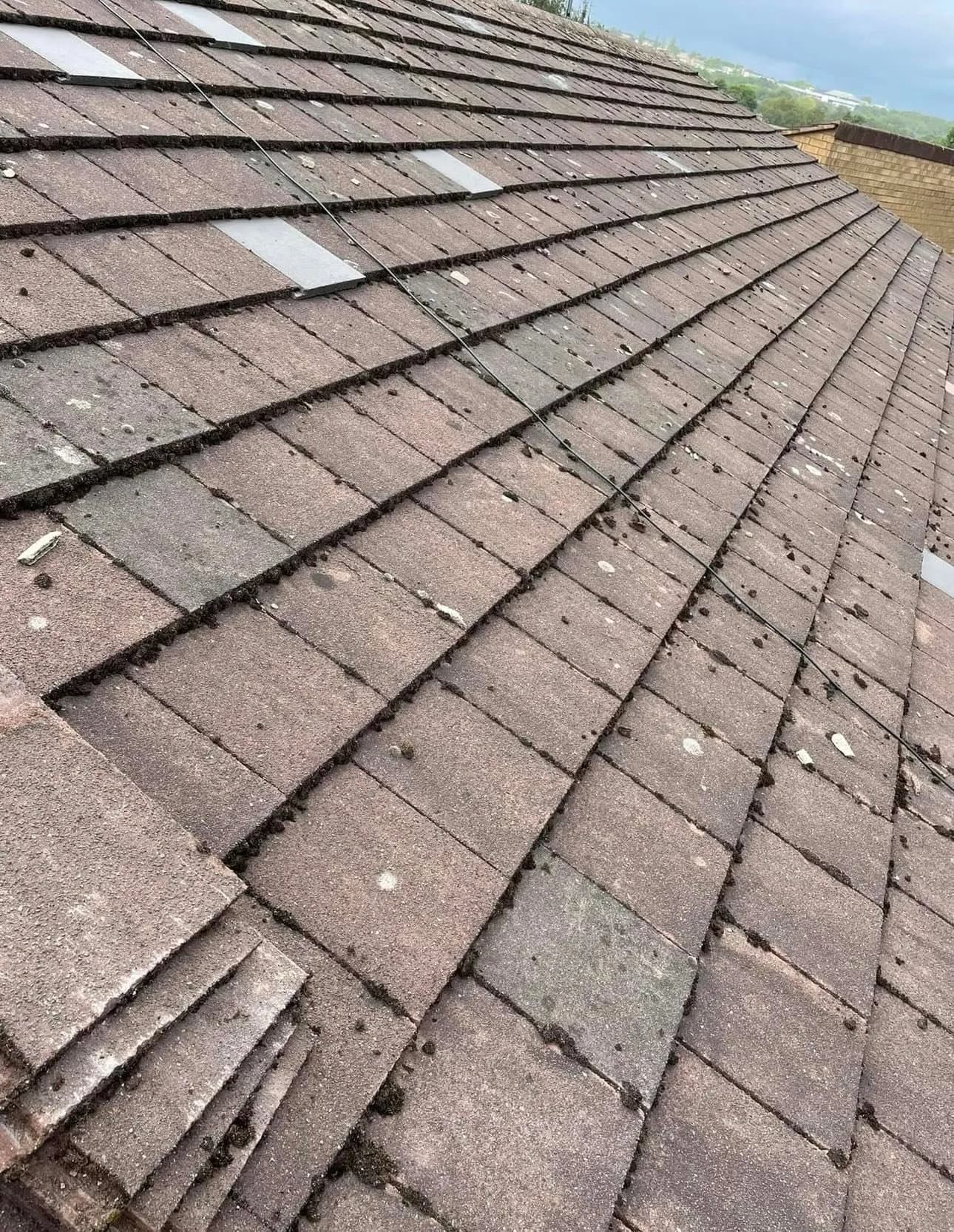 Weathered old tiles, some slipped, before the work